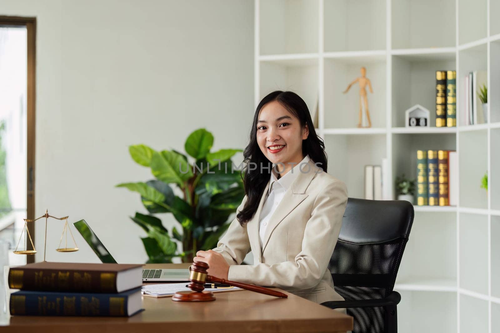 Woman lawyer confident working about ducument at desk and looking at camera.