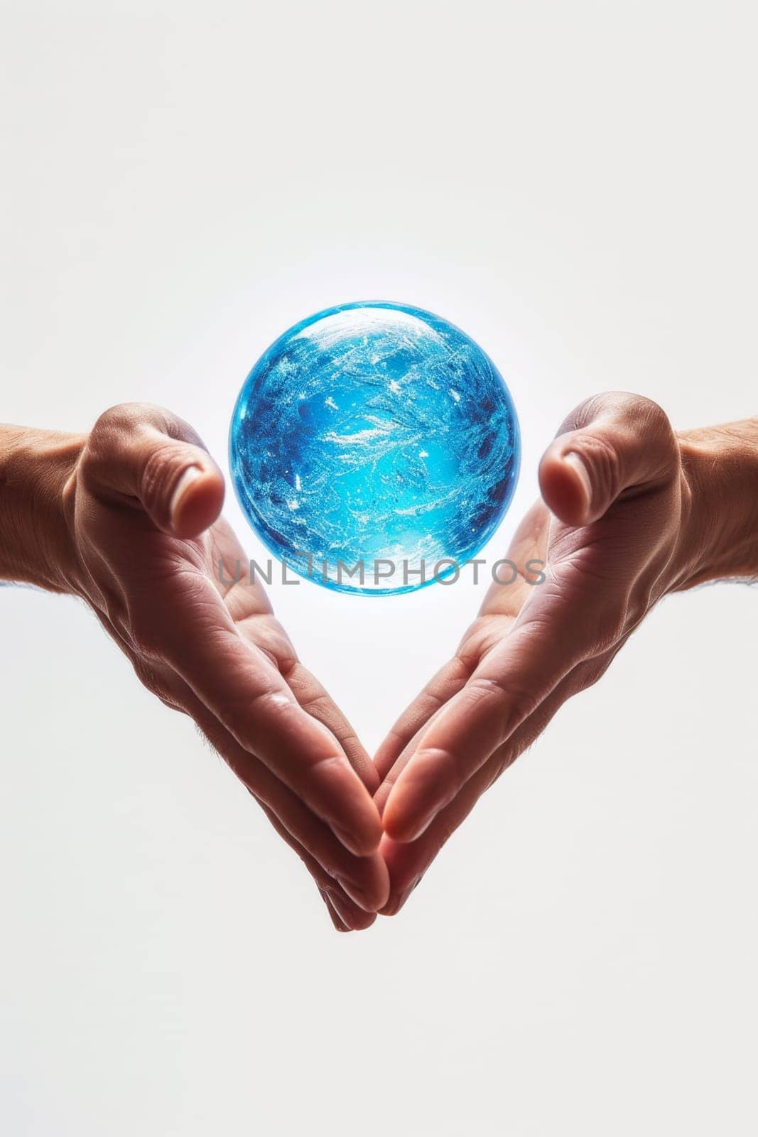 A blue energy ball in the hands of a man on a white background.