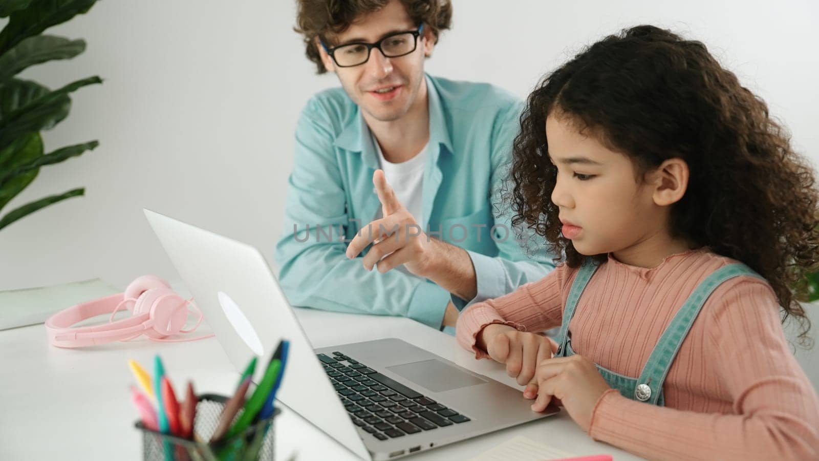 Caucasian father help student doing homework about engineering code. Pedagogy. by biancoblue