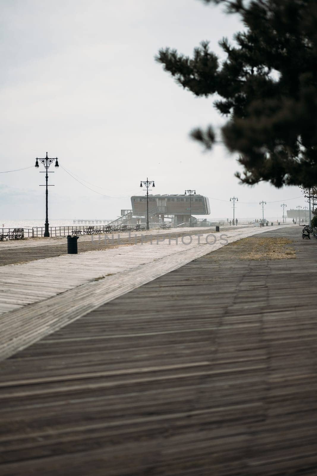 Desolate Boardwalk Leading to a Distant Building in New York by apavlin