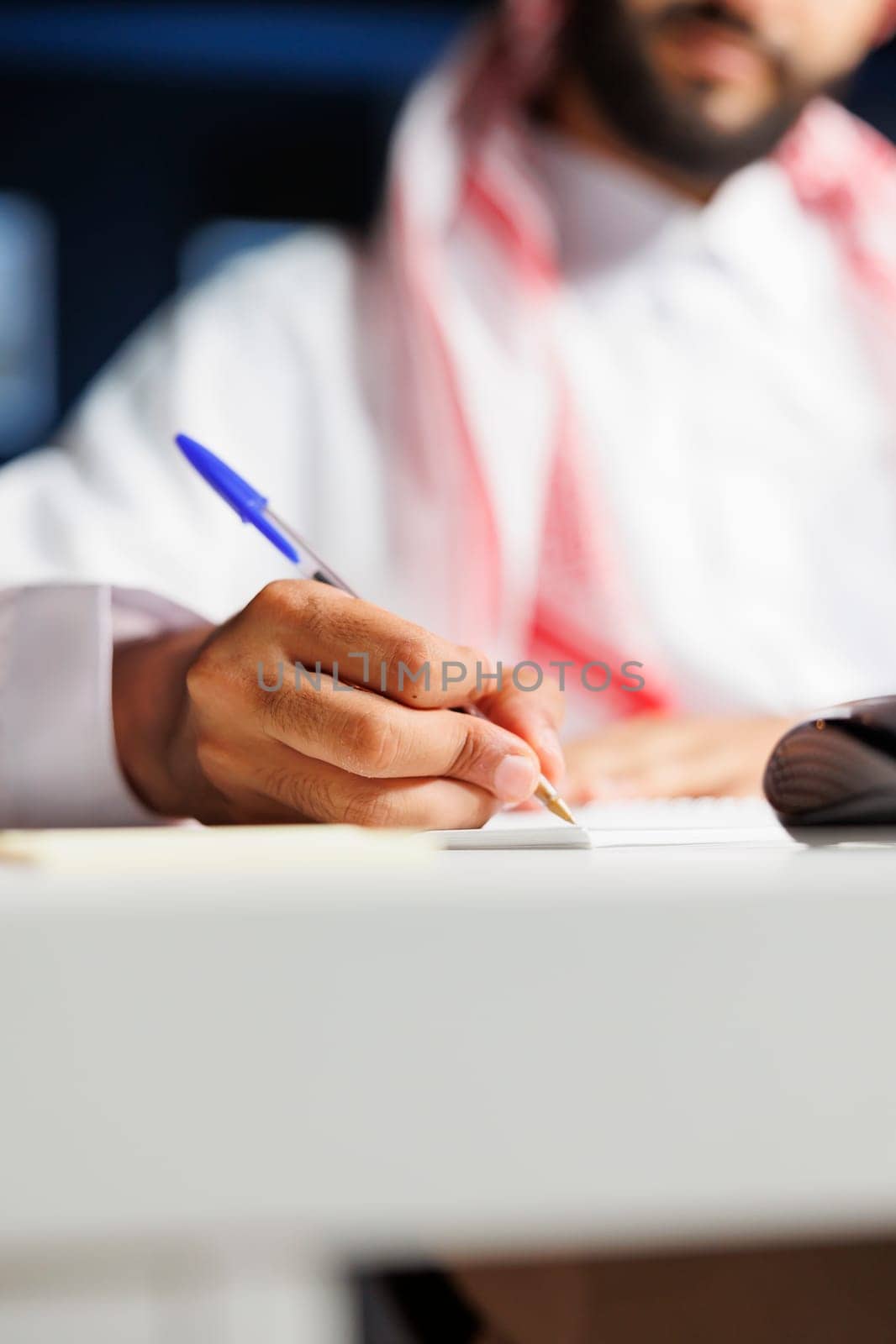 Businessman writing on his notebook by DCStudio