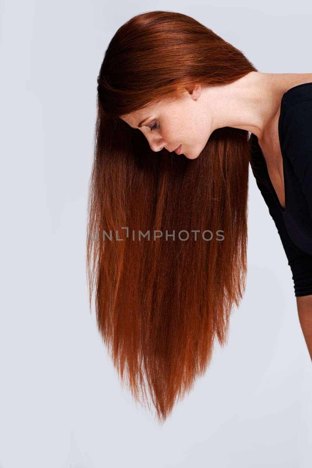 Woman, red hair and beauty with cosmetic care, keratin treatment for shine with healthy growth on white background. Redhead, ginger and haircare for wellness, volume and texture with length in studio.