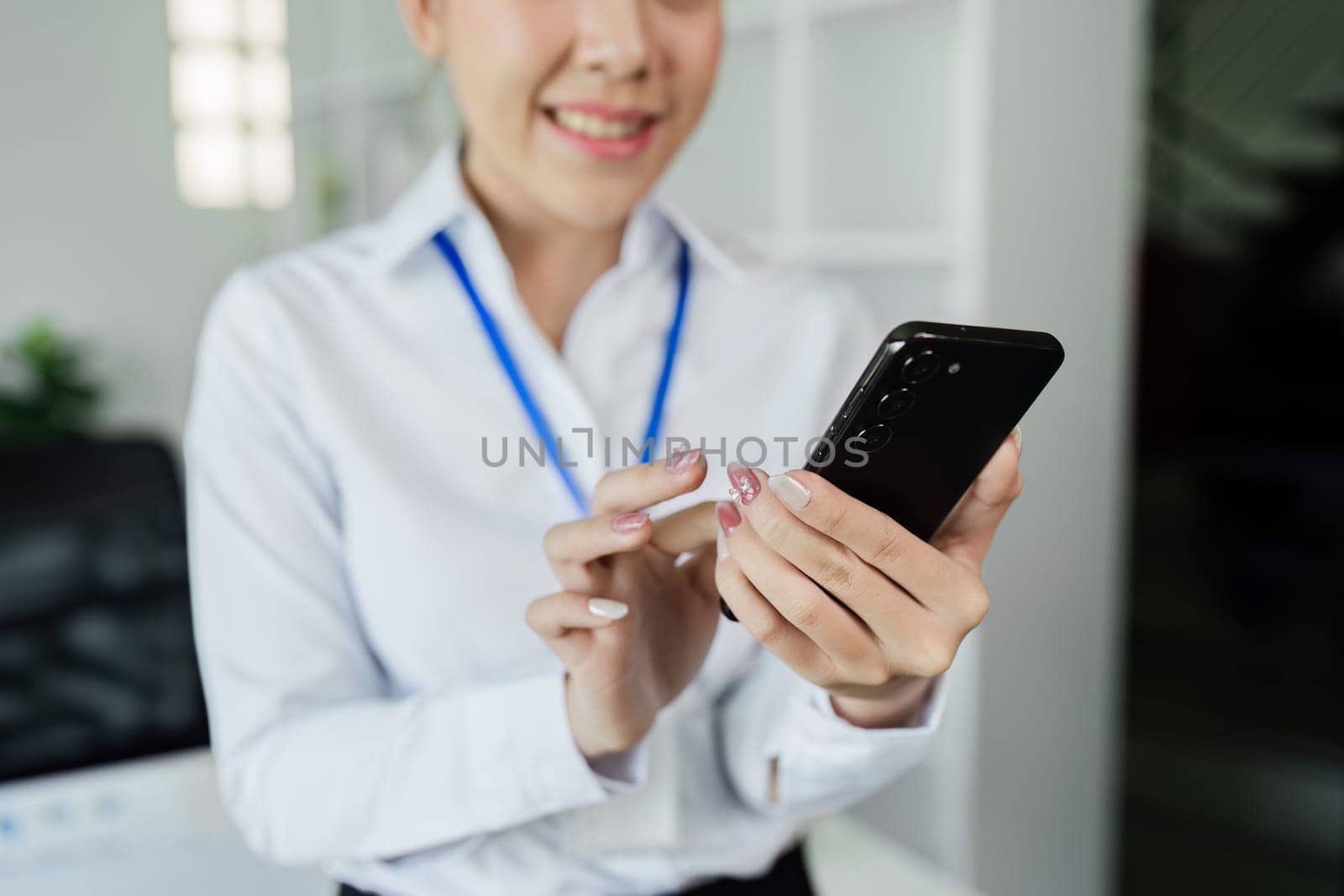 Business woman using mobile chatting with client, business partner for business meeting by itchaznong