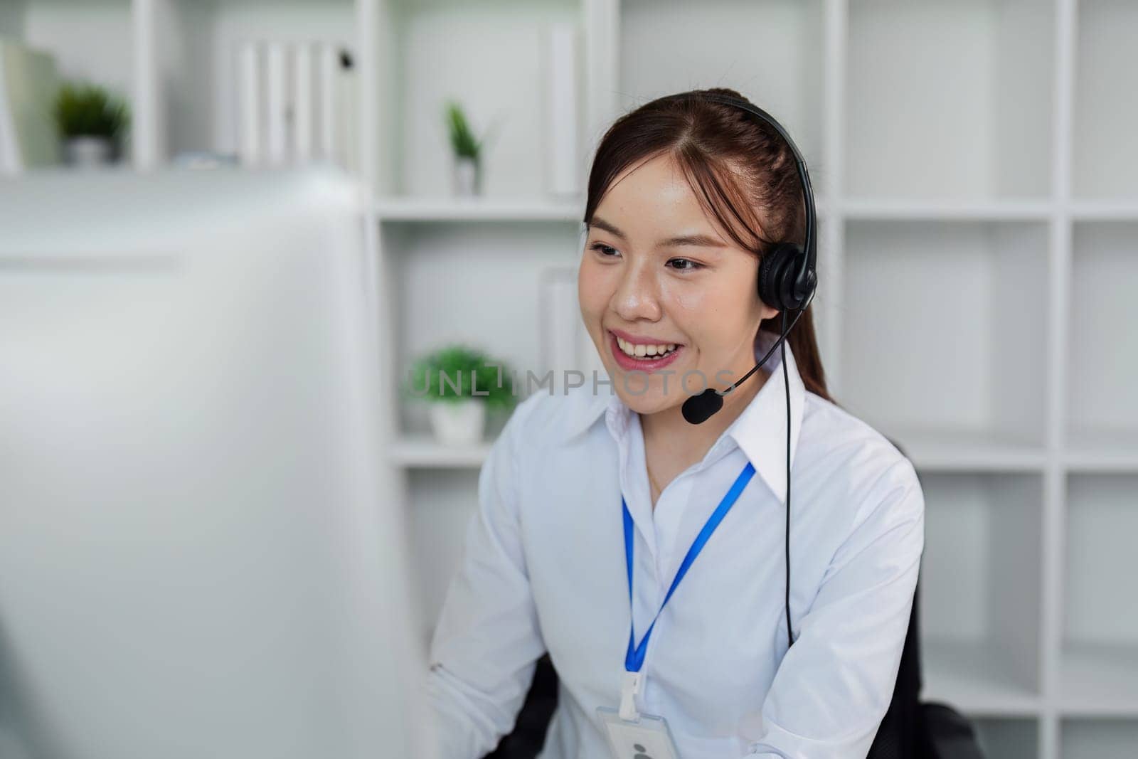Customer service, woman and happy call center agent giving advice online using a headset by itchaznong
