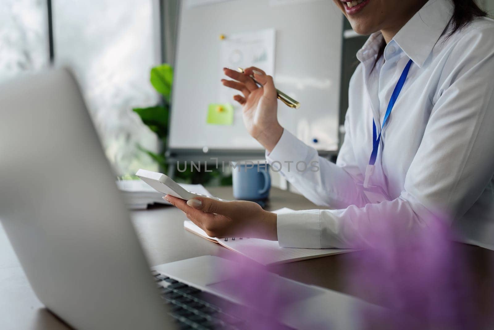 Business finance concept, Business woman using calculator to calculate business data at office.