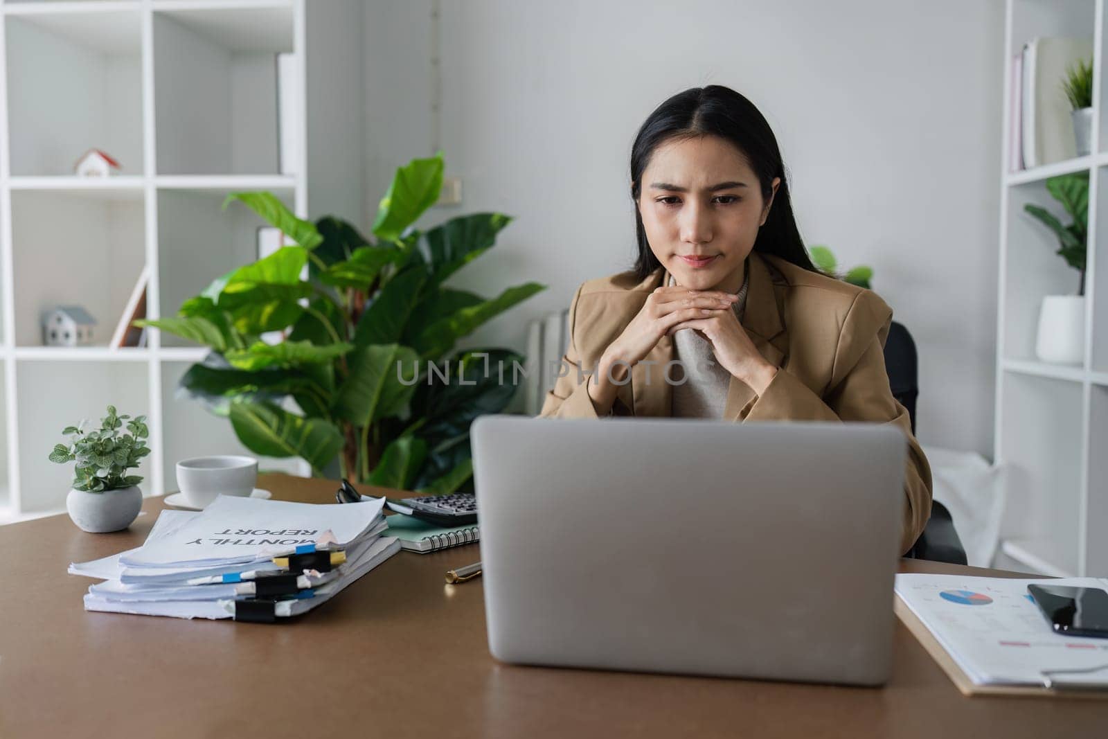 business woman entrepreneur in office using laptop at work, stress professional female company executive wearing suit working on computer at workplace by itchaznong