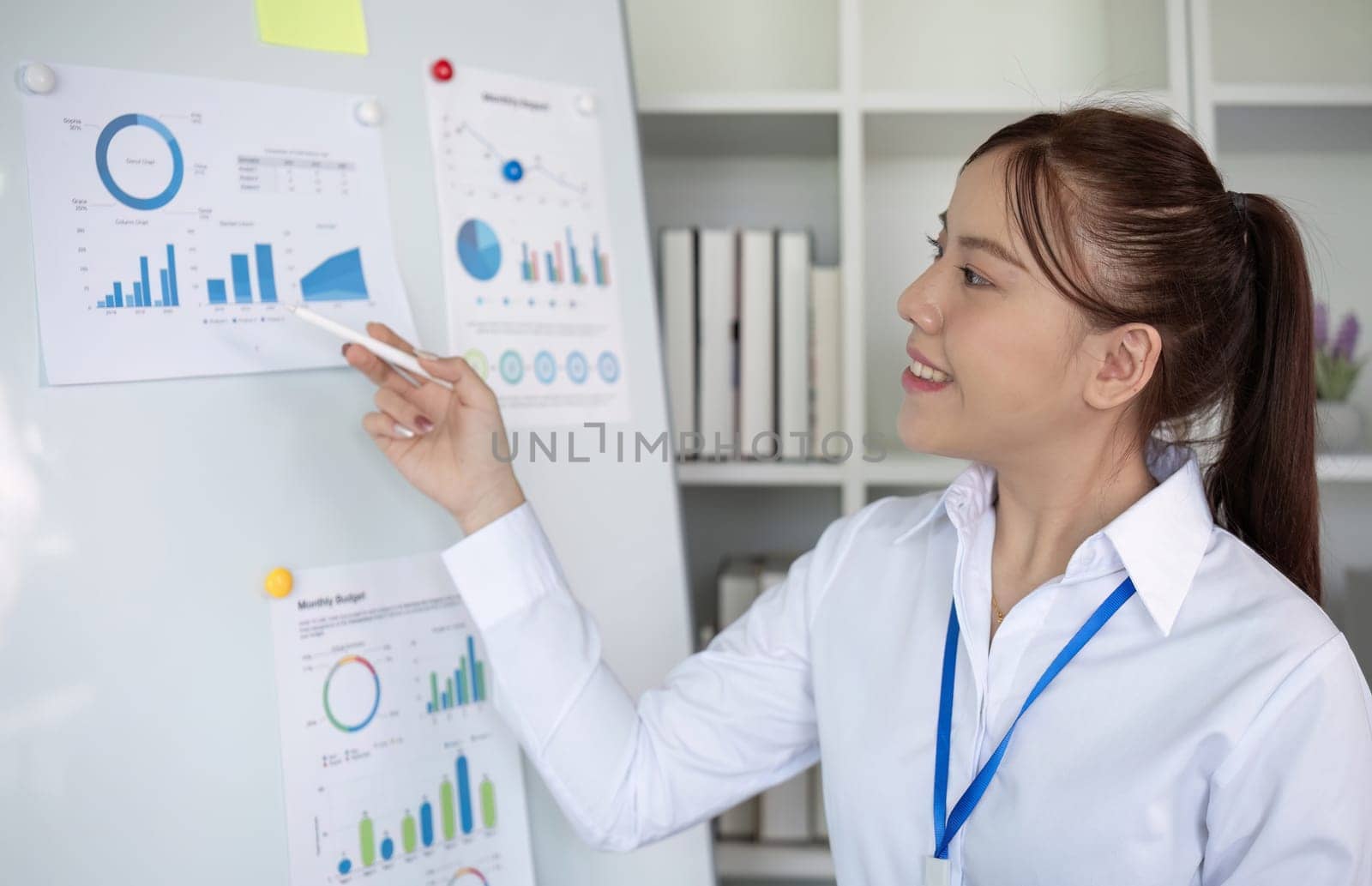 Businesswoman with presentation board at a meeting about work plans Finance and business results graphs.