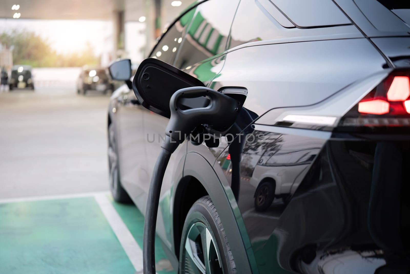 Charging electric cars at charging stations Using electric cars that save energy and reduce air pollution by wichayada