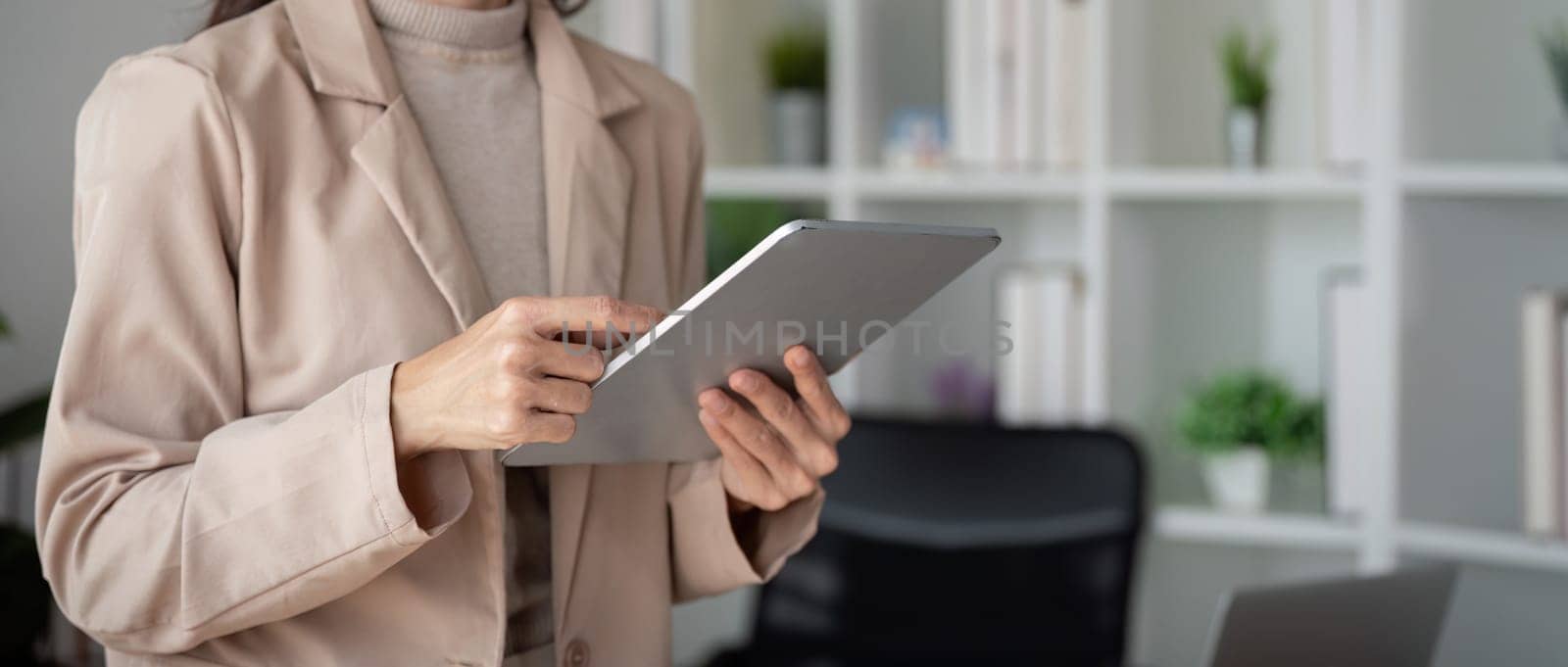 Young business woman work use hold tablet stand at workplace desk at office . Achievement career concept, lifestyle concept.