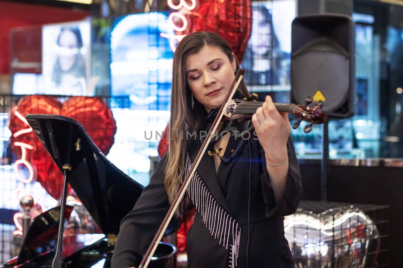 Belarus, Minsk - 07 february, 2024: Cute girl playing the violin