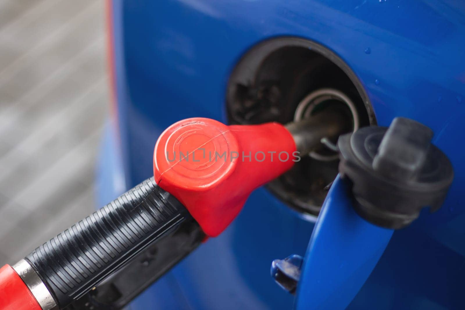 Refueling a car at a gas station close up