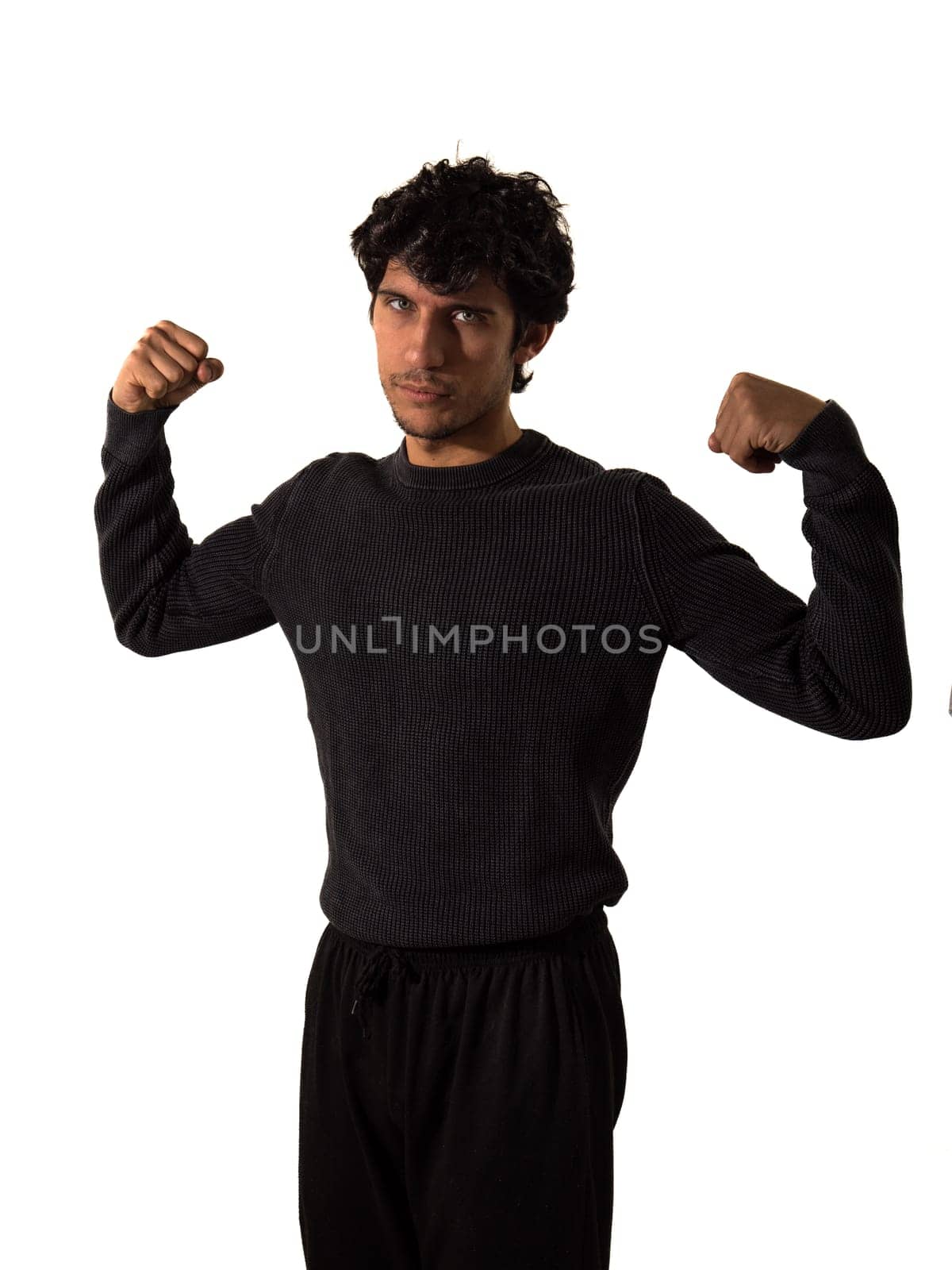 Muscular man in black sweater flexing by artofphoto