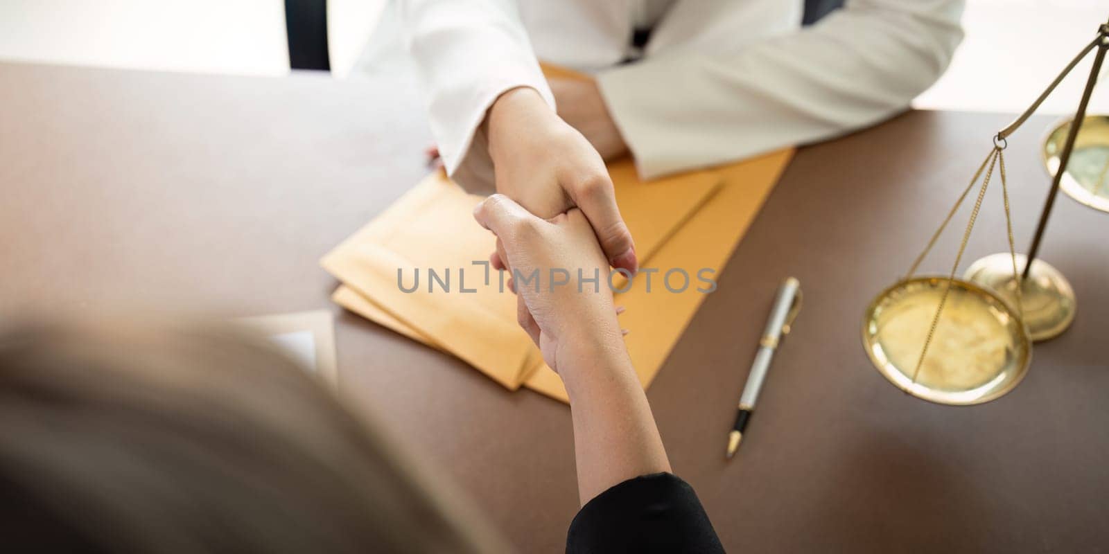 Businesswoman handshake to seal a deal judge female lawyers consultation legal services Consulting in regard to the various contract by nateemee