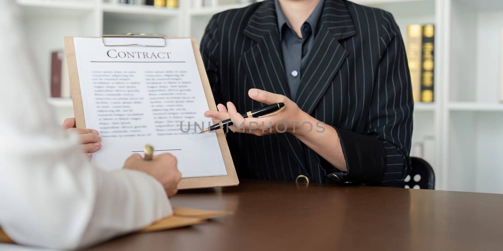 Lawyer office the company hired the lawyer office a legal advisor and draft the contract so that the client could signs contract. Contract of sale was on the table in the lawyer office by nateemee