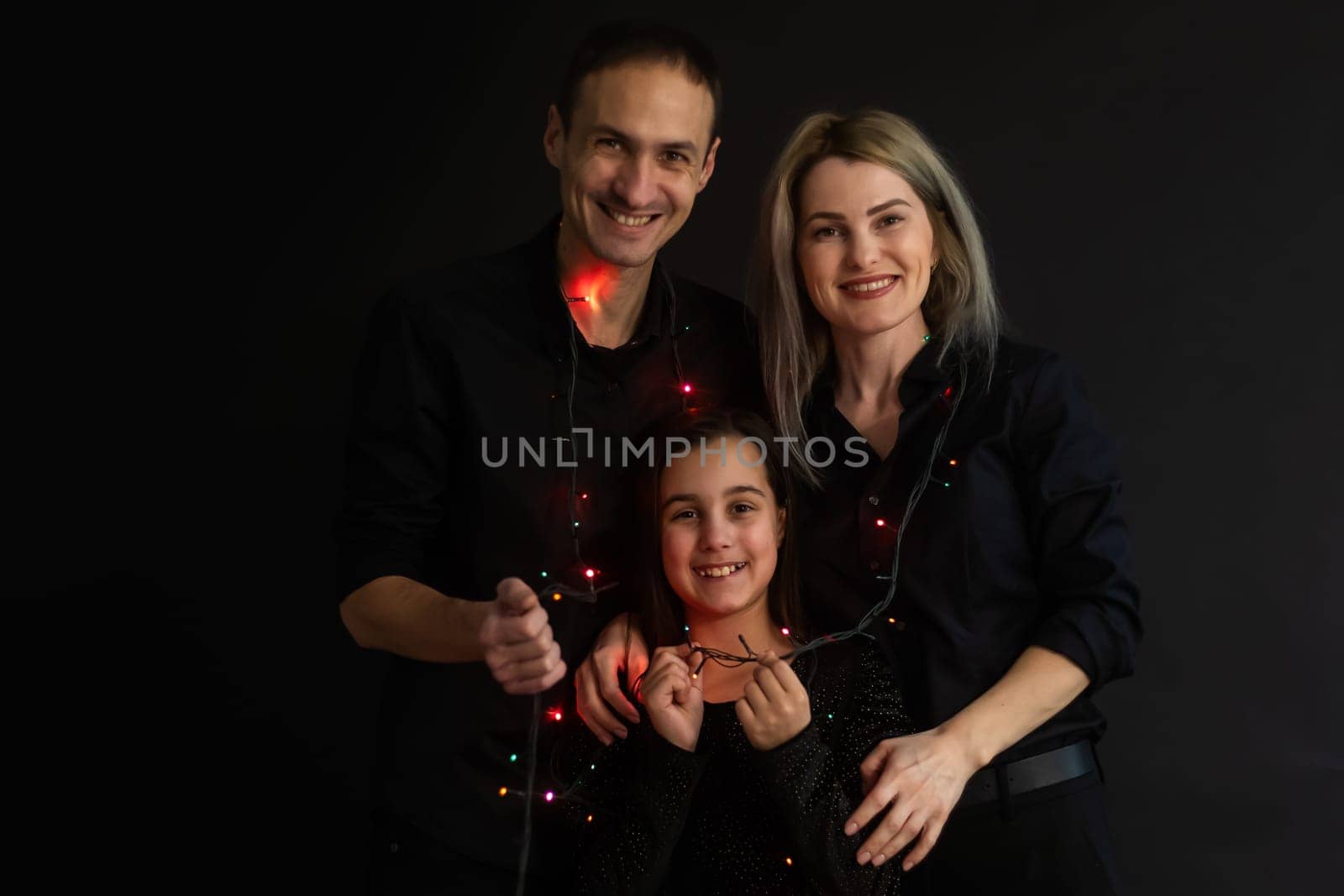 family with garland on a black background.