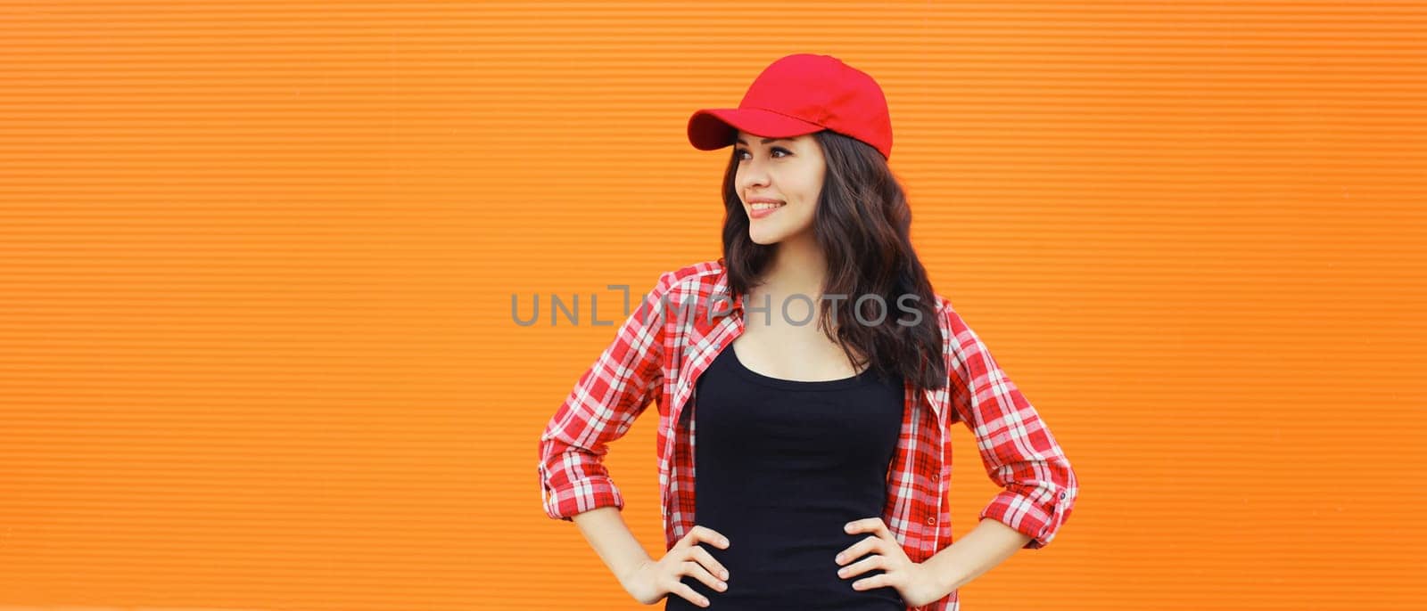 Summer portrait of happy smiling young woman posing in red baseball cap, casual clothes by Rohappy