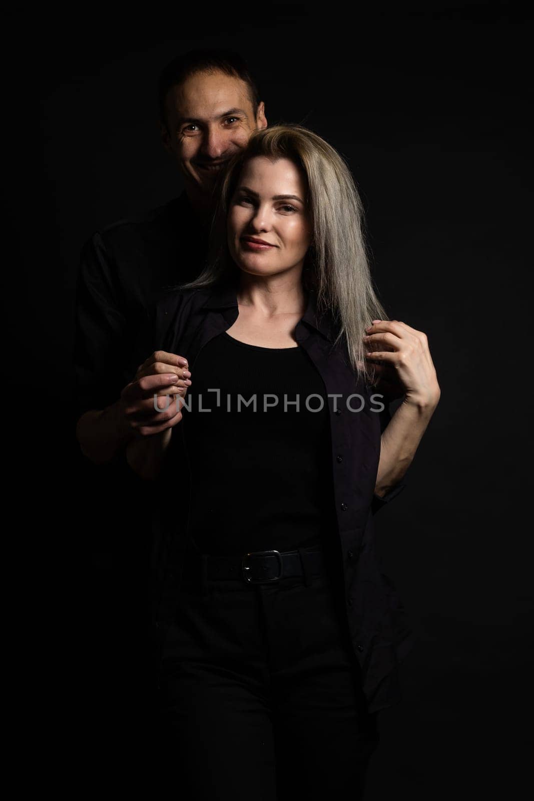 portrait of fashion couple on black background.