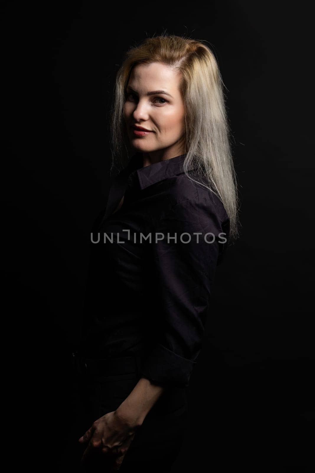 Blonde woman portrait, attractive adult girl in studio over black background. by Andelov13