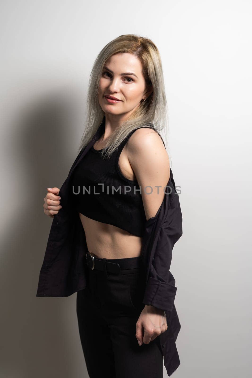 Image of happy young business woman posing isolated over grey wall background