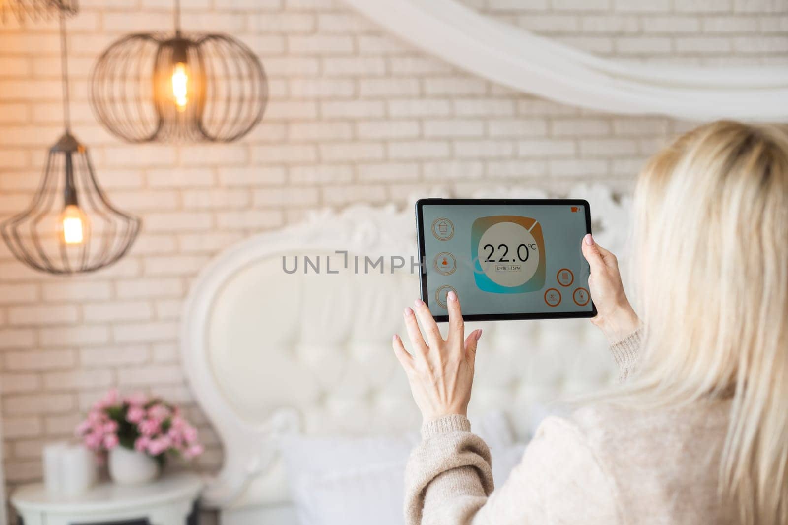 A woman holding a tablet with smart home screen by Andelov13