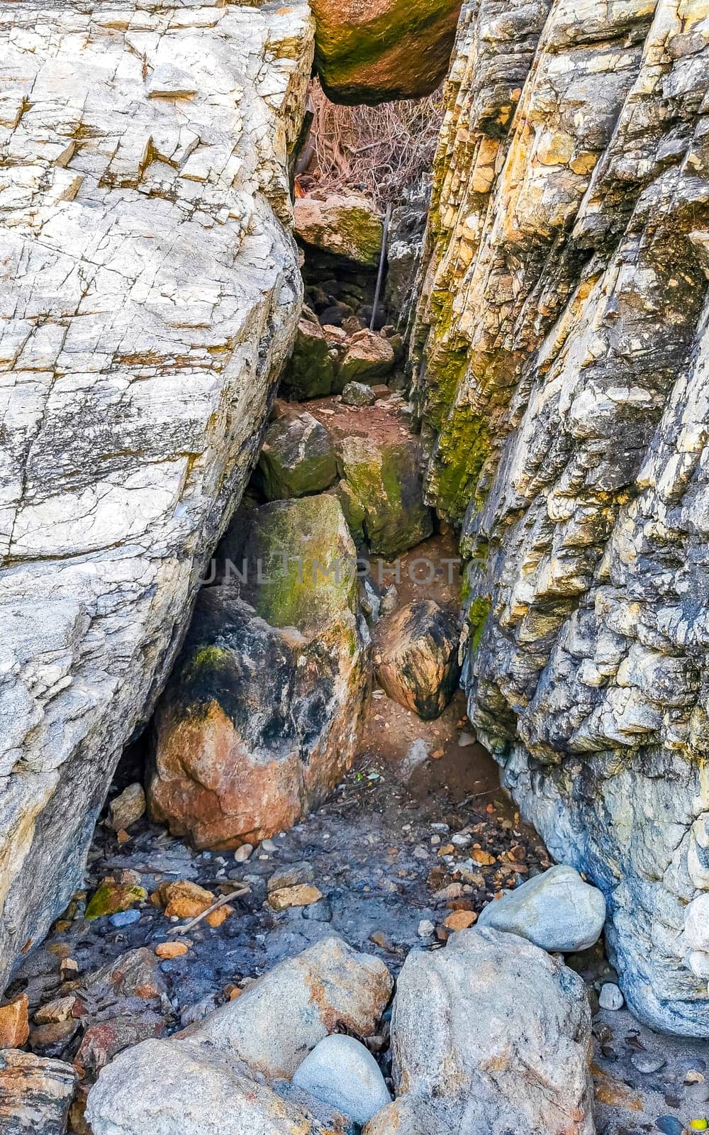 Beautiful rocks cliffs stones and boulders on mountain with natural stairs on the beach in Zicatela Puerto Escondido Oaxaca Mexico.