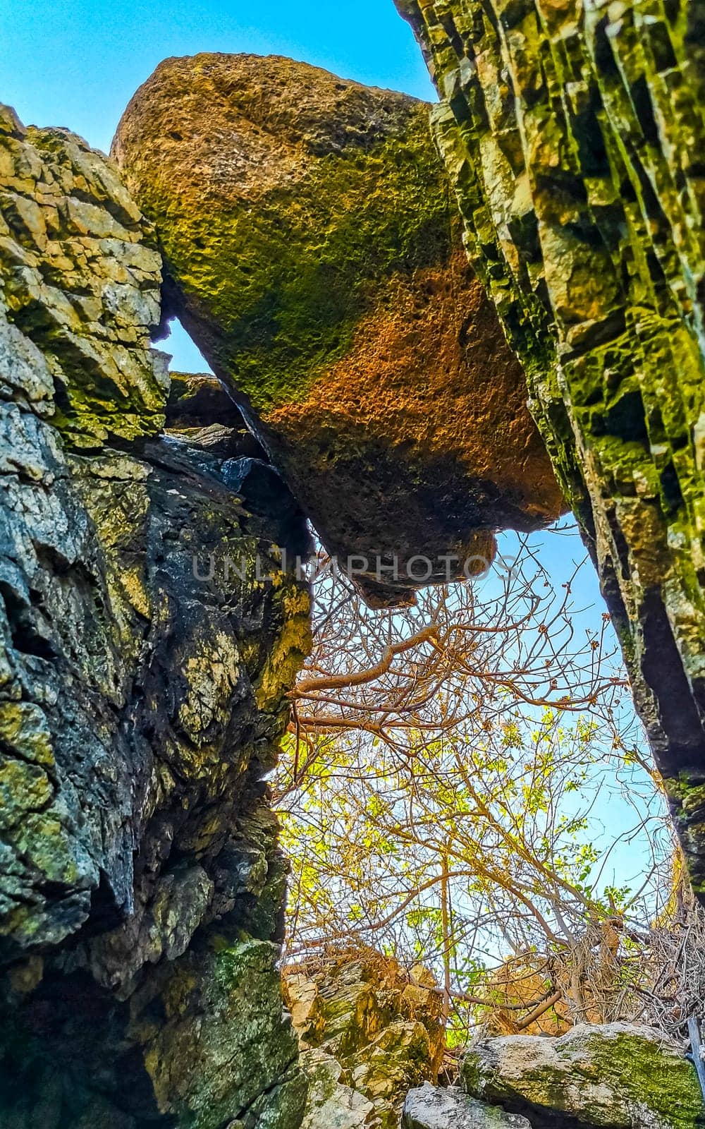 Beautiful rocks cliffs stones and boulders on mountain big giant rock stuck between mountains in Zicatela Puerto Escondido Oaxaca Mexico.