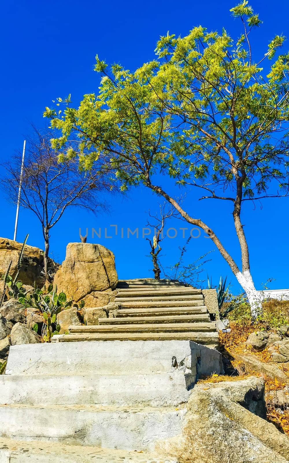 Beautiful rocks cliffs stones and boulders on mountain with natural stairs on the beach in Zicatela Puerto Escondido Oaxaca Mexico.