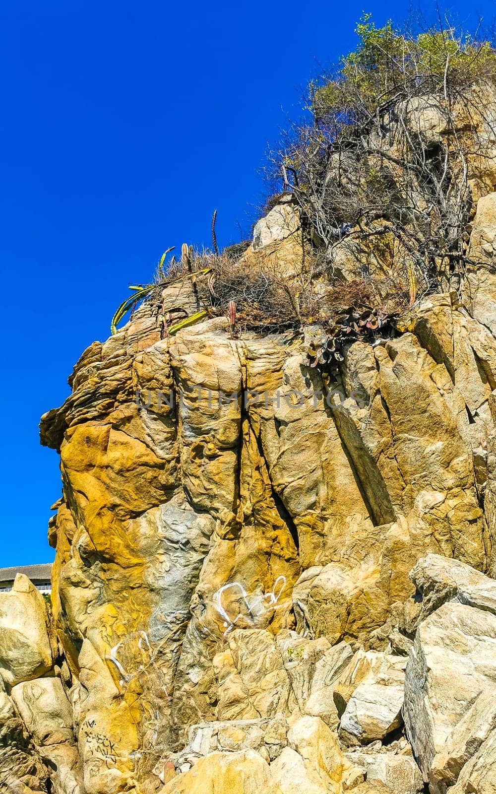 Beautiful rocks cliffs stones and boulders on mountain with natural stairs on the beach in Zicatela Puerto Escondido Oaxaca Mexico.