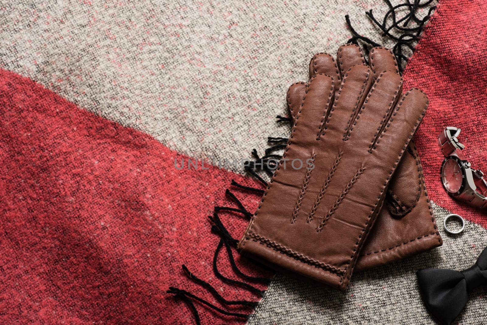 Pair of men's brown leather gloves and other men's accessories.