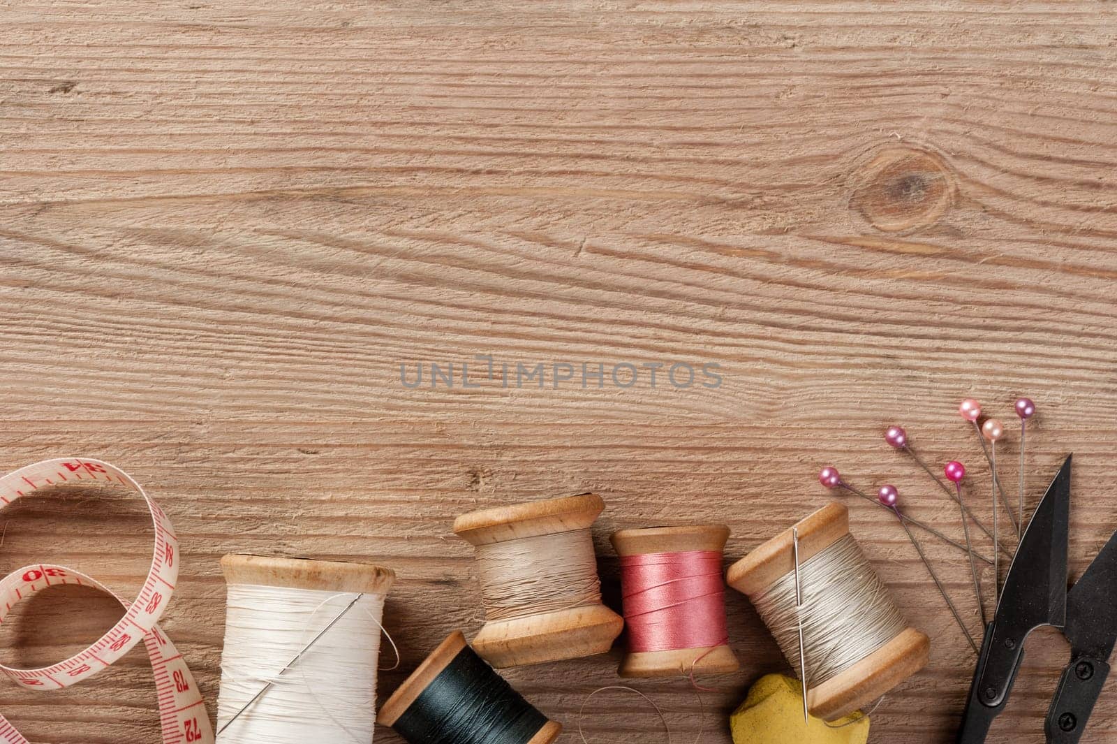 closeup thread for sewing and needlework on wooden background