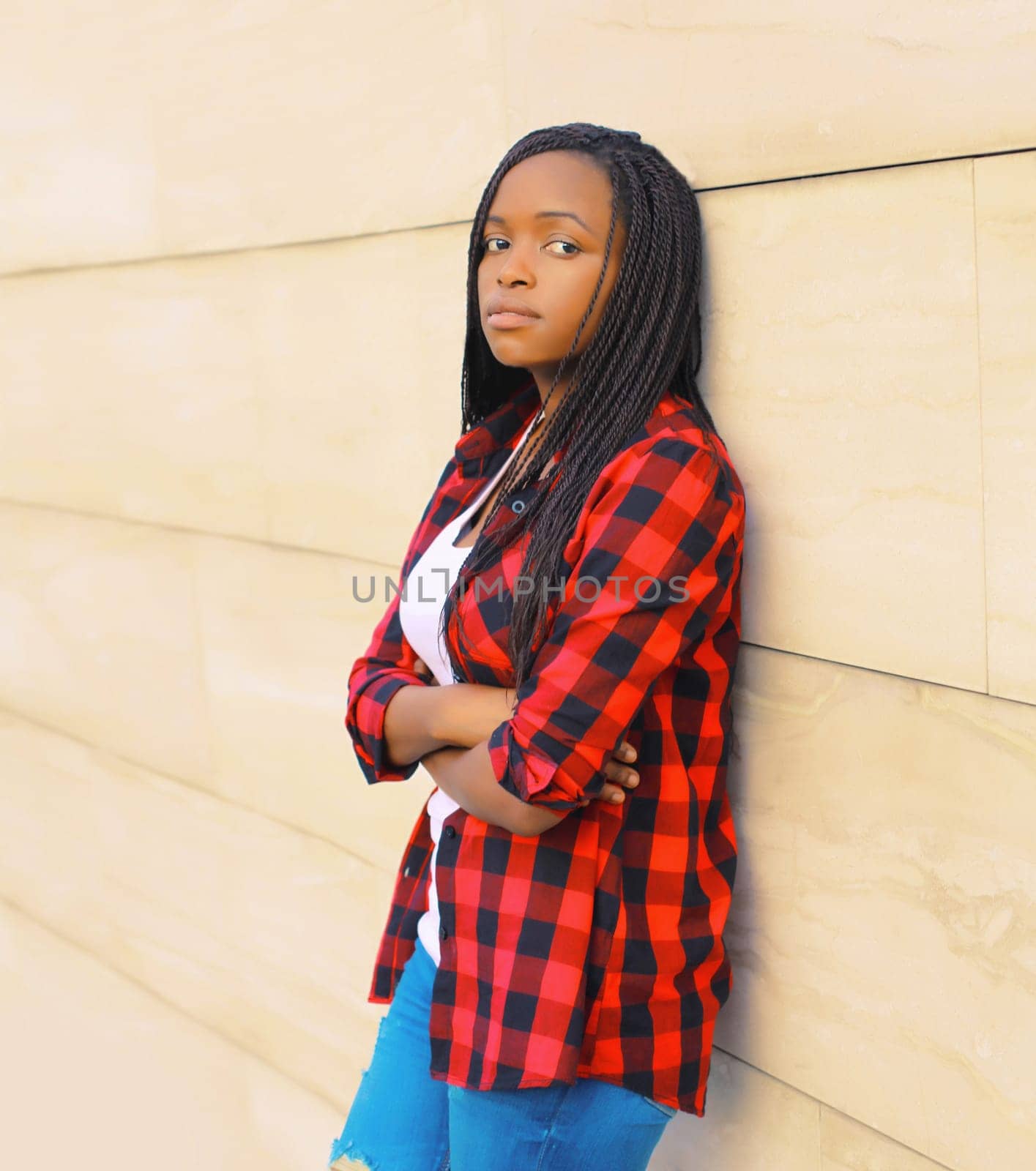 Portrait of beautiful young african woman posing wearing casual in the city