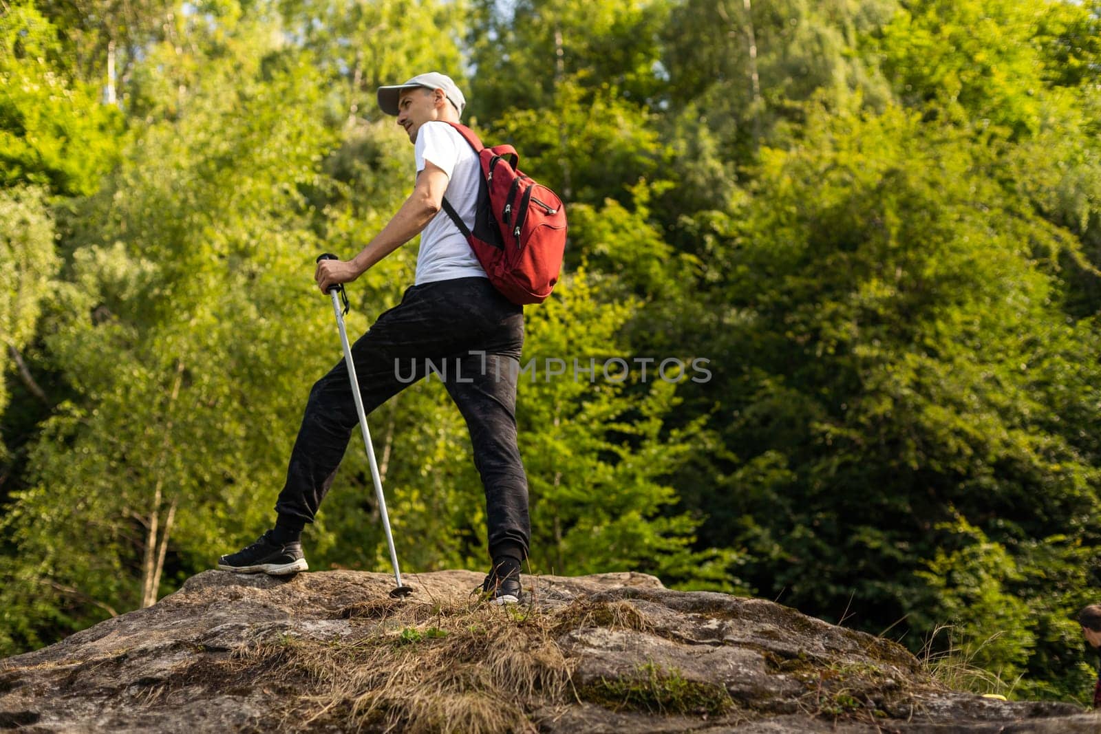 Man hiking in the mountains with a backpack.