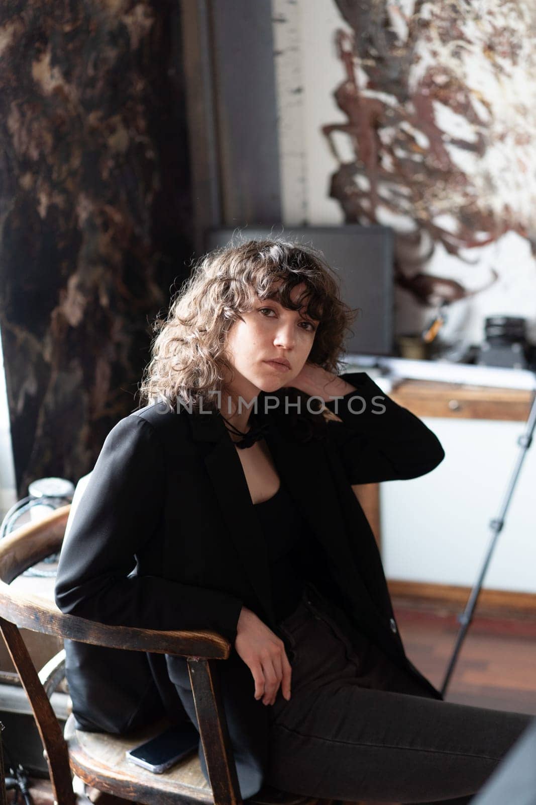 portrait of a young beautiful woman with curly hair in the studio