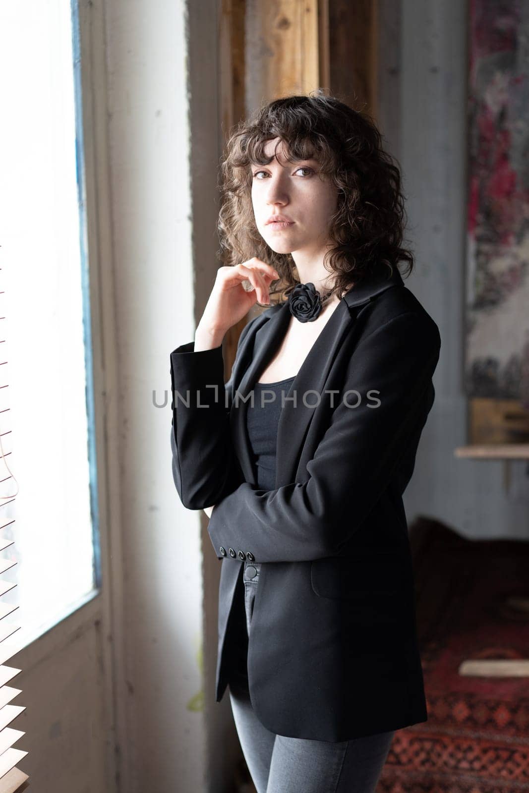 portrait of a young beautiful woman with curly hair in the studio