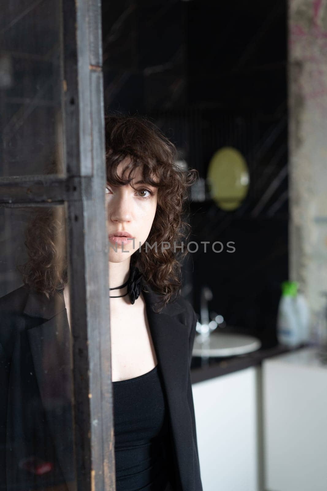 portrait of a young beautiful woman with curly hair in the studio