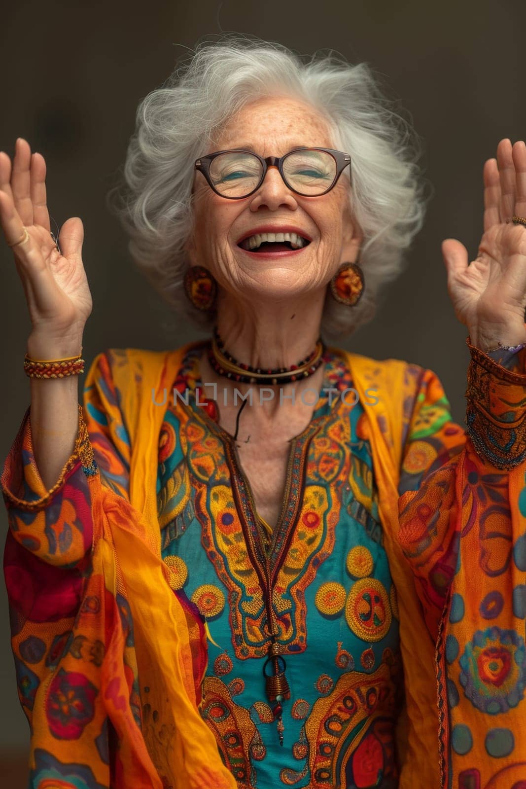 A happy and playful elderly woman in colored clothes.