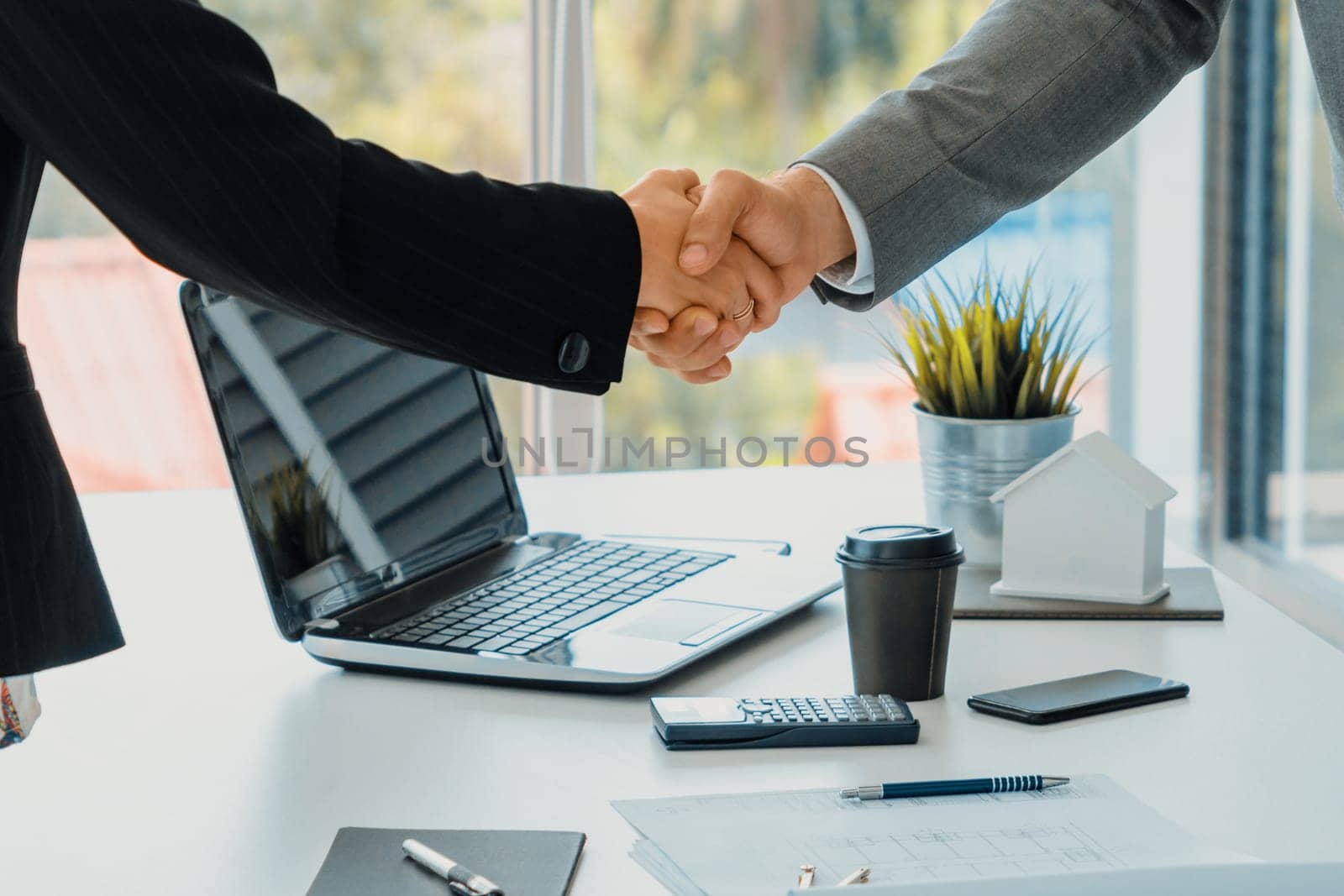 Businessman executive handshake with businesswoman worker in modern workplace office. People corporate business deals concept. uds