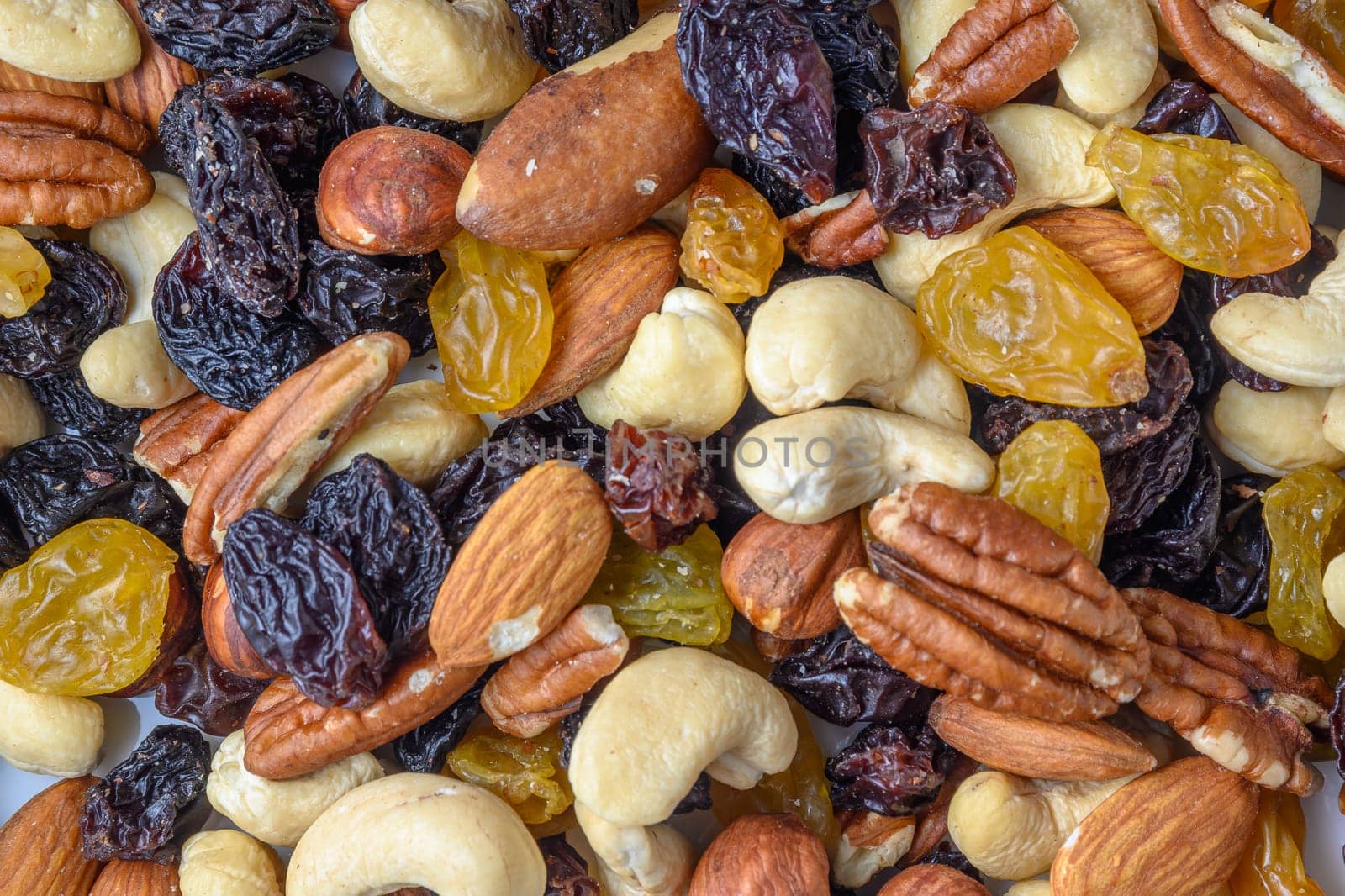 background with a cashew, hazelnuts, raisins and peanuts. Mixed nuts and raisins texture.12 by Mixa74