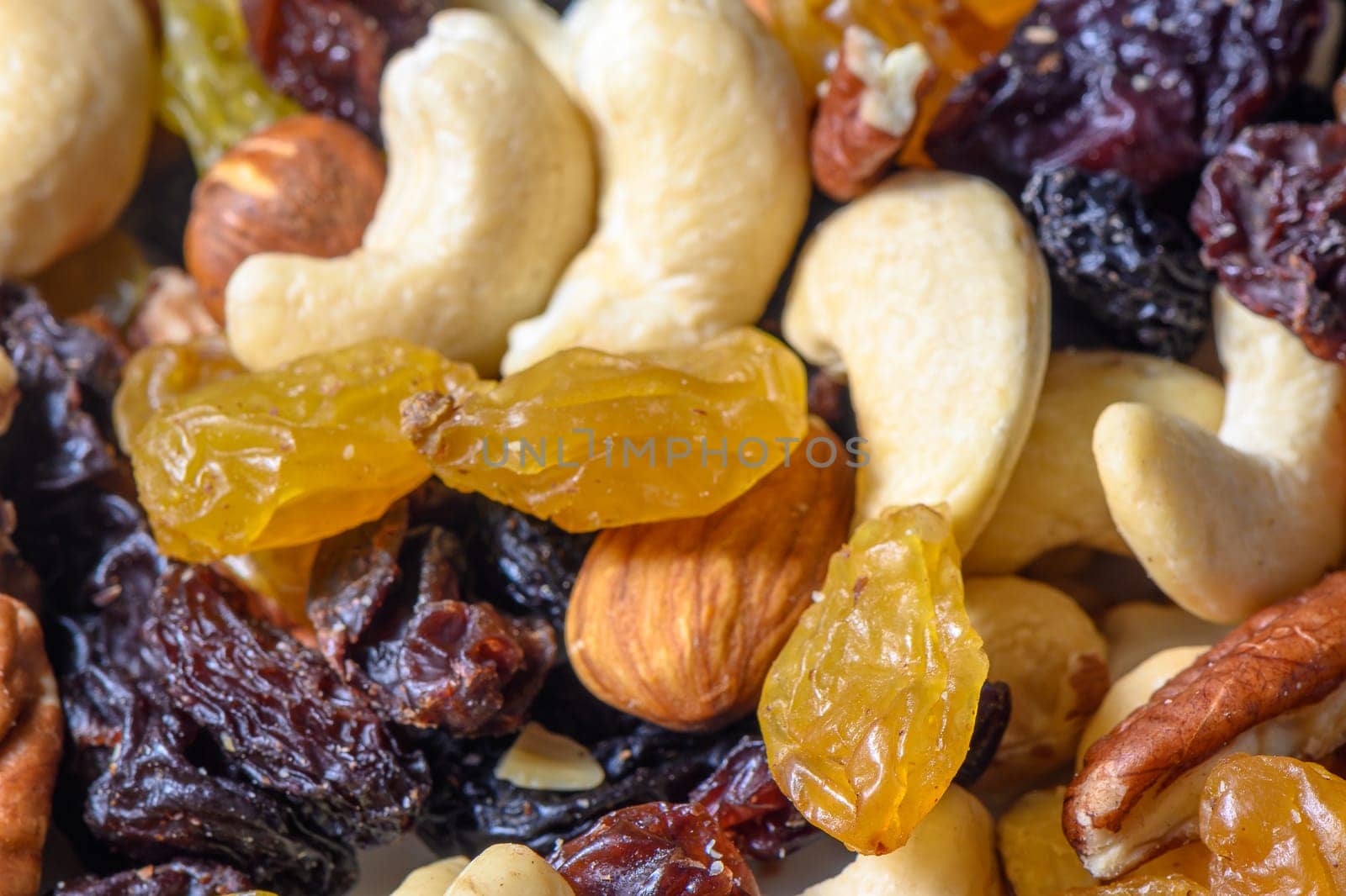 background with a cashew, hazelnuts, raisins and peanuts. Mixed nuts and raisins texture.10 by Mixa74