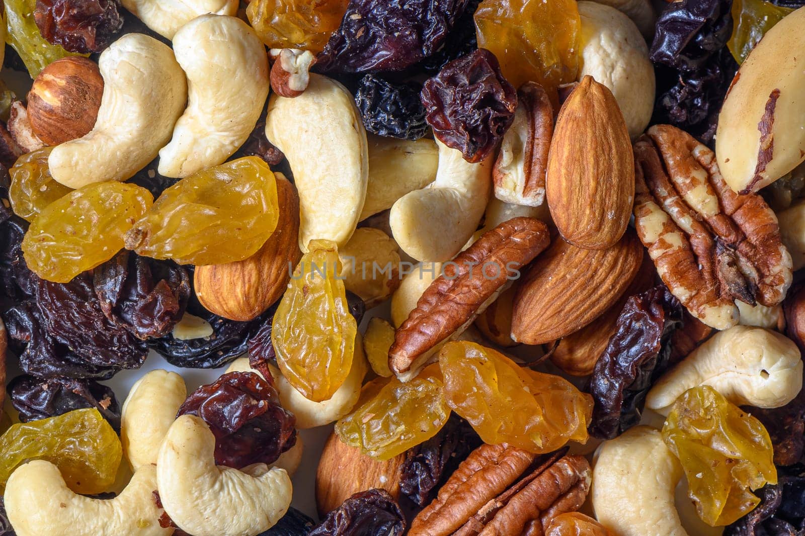 background with a cashew, hazelnuts, raisins and peanuts. Mixed nuts and raisins texture.9 by Mixa74