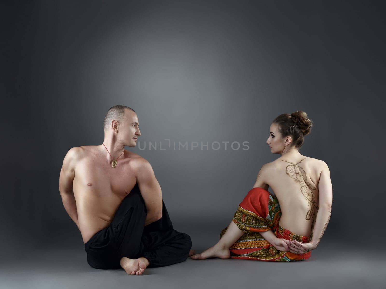 Yoga in pairs. People exercising, looking at each other