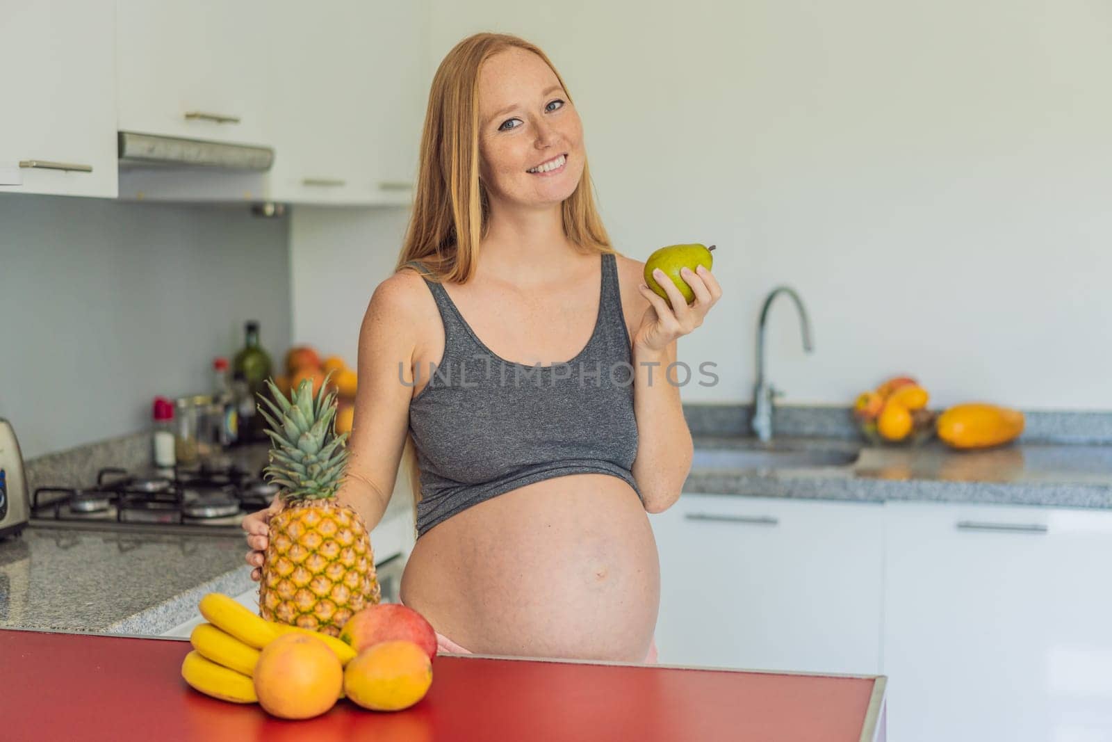 Embracing a healthy choice, a pregnant woman prepares to enjoy a nutritious moment, gearing up to eat fresh fruit and nourish herself during her pregnancy by galitskaya