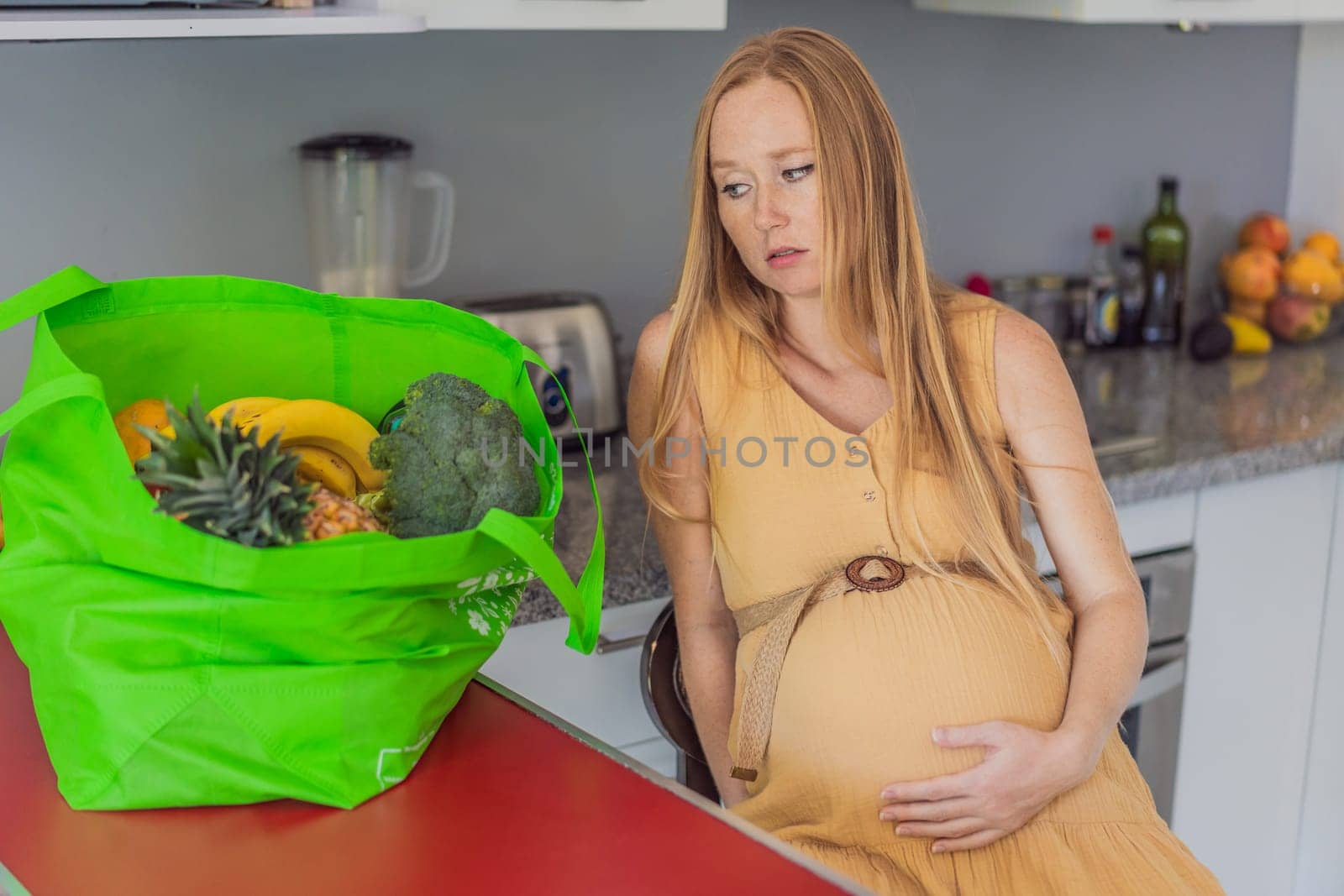 Exhausted but resilient, a pregnant woman feels fatigue after bringing home a sizable bag of groceries, showcasing her dedication to providing nourishing meals for herself and her baby by galitskaya