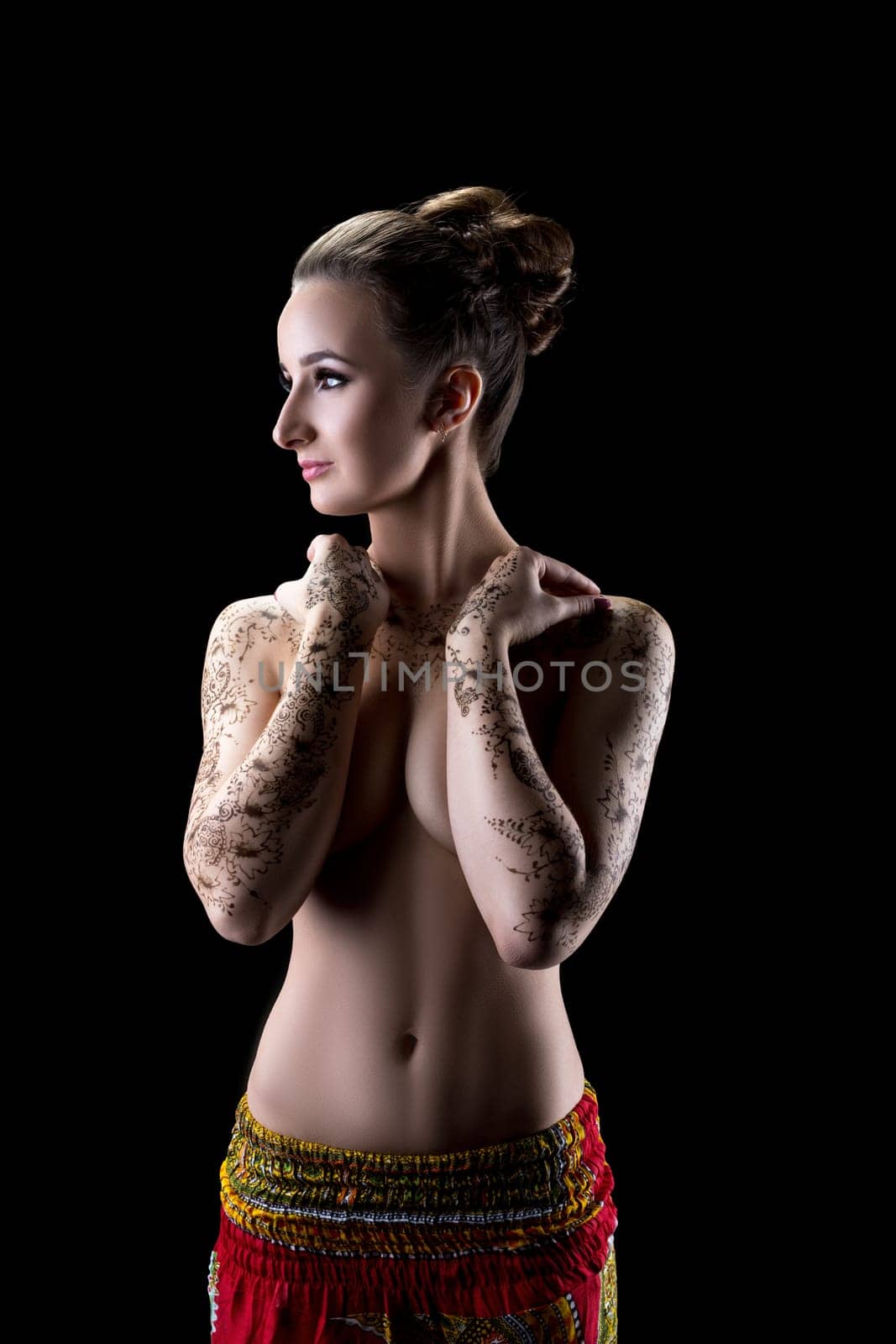 Image of sensual topless woman with henna pattern on her hands