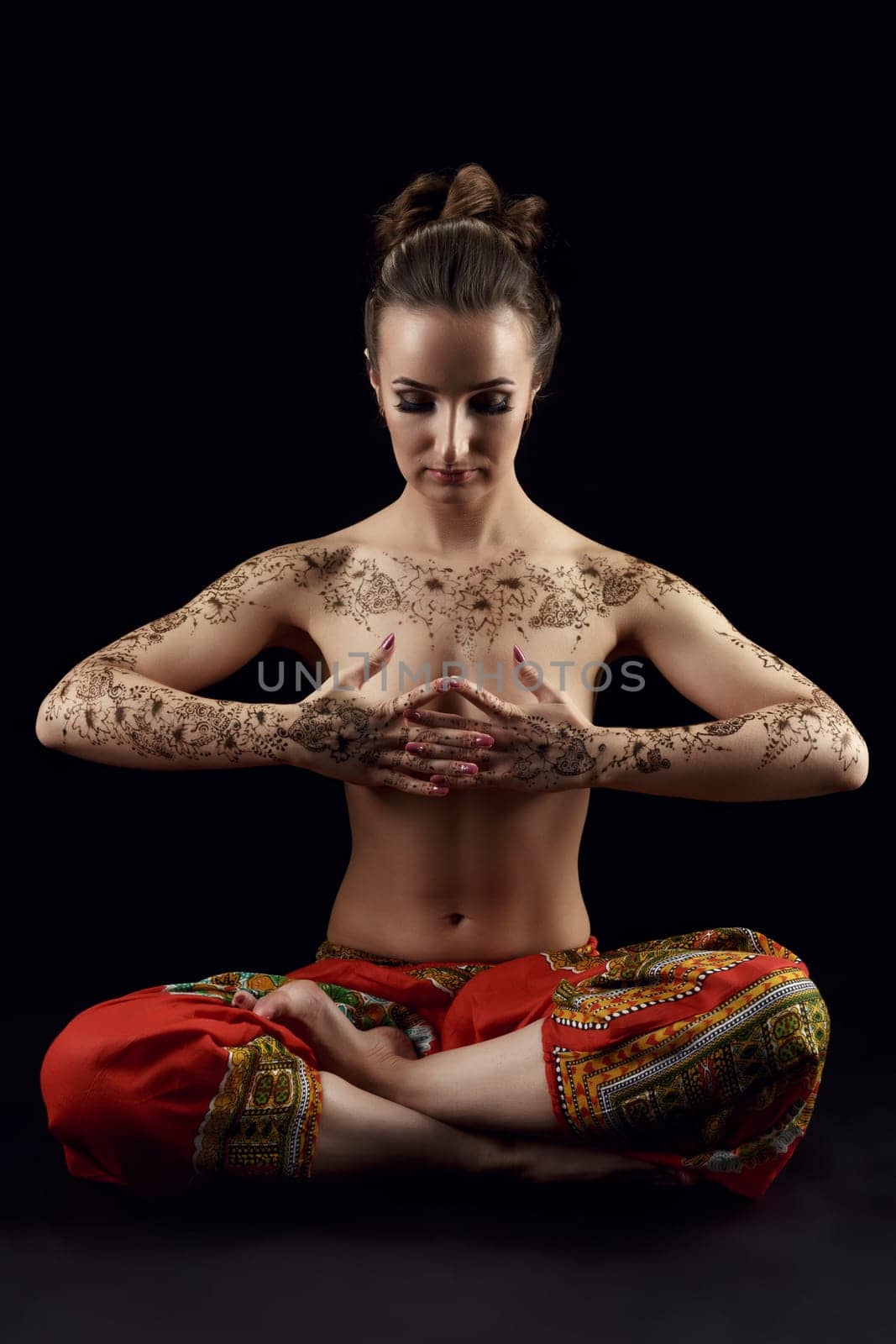 Yoga. Woman's body covered with beautiful floral patterns