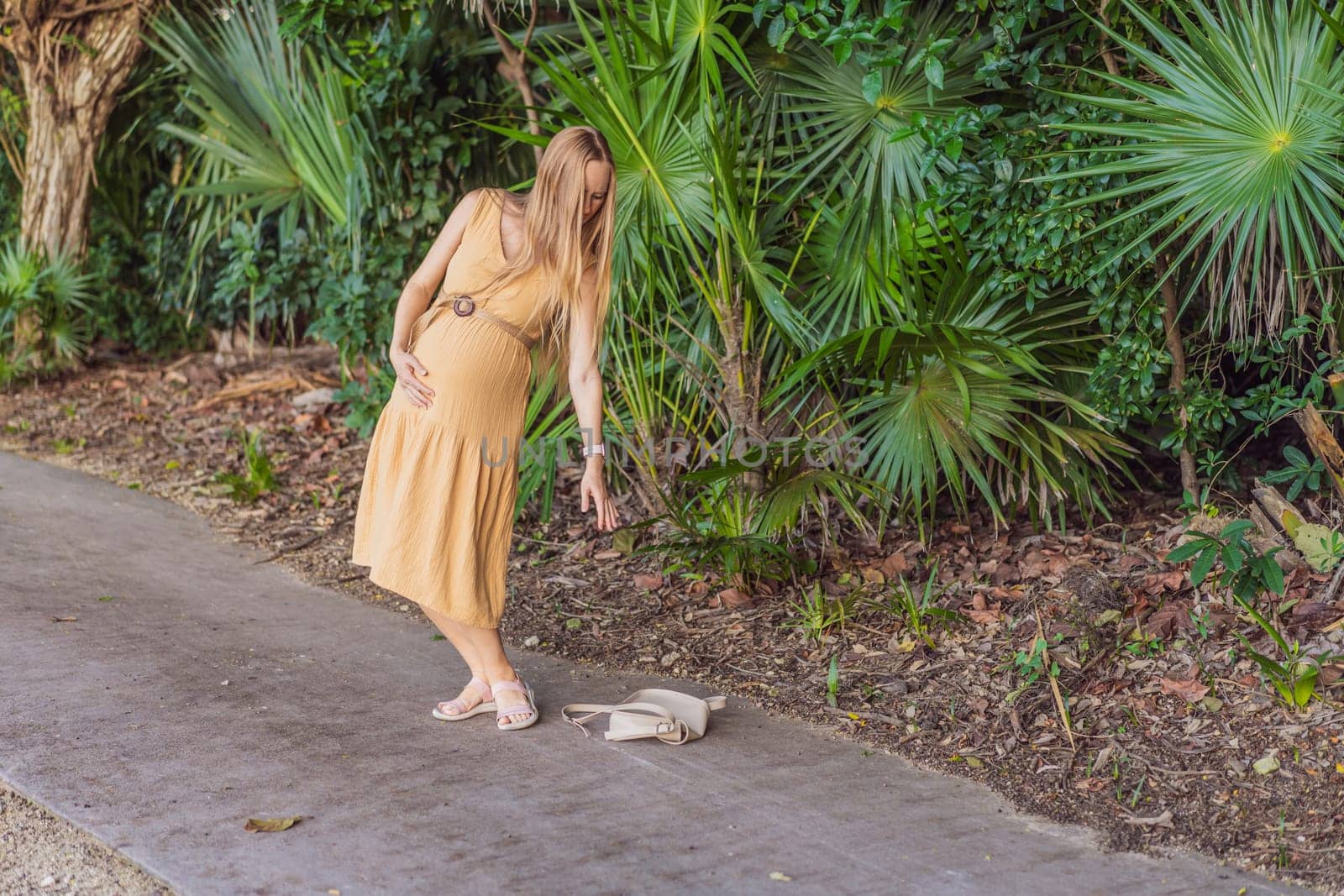 pregnant woman drops her keys and struggles to pick them up, highlighting the physical limitations that can arise during pregnancy. Patience and support become essential.