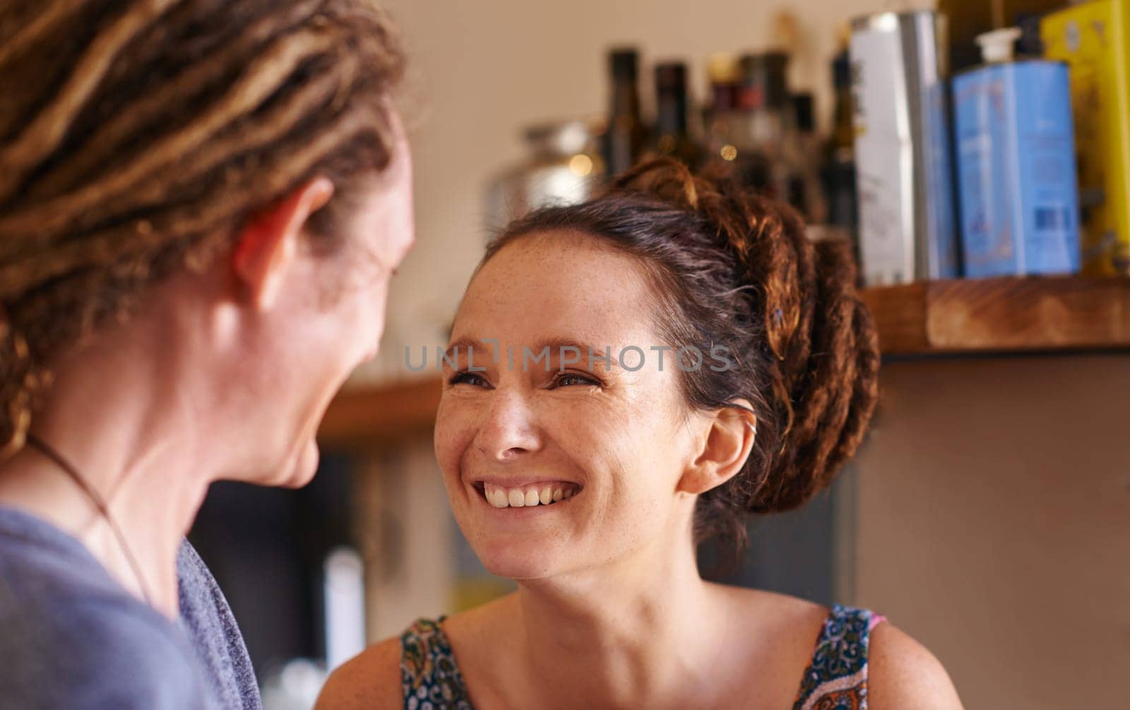 Couple, laugh and happy in kitchen for love or bonding with affection, romance and care with support. Man, woman and together for commitment or security, safety and trust with communication