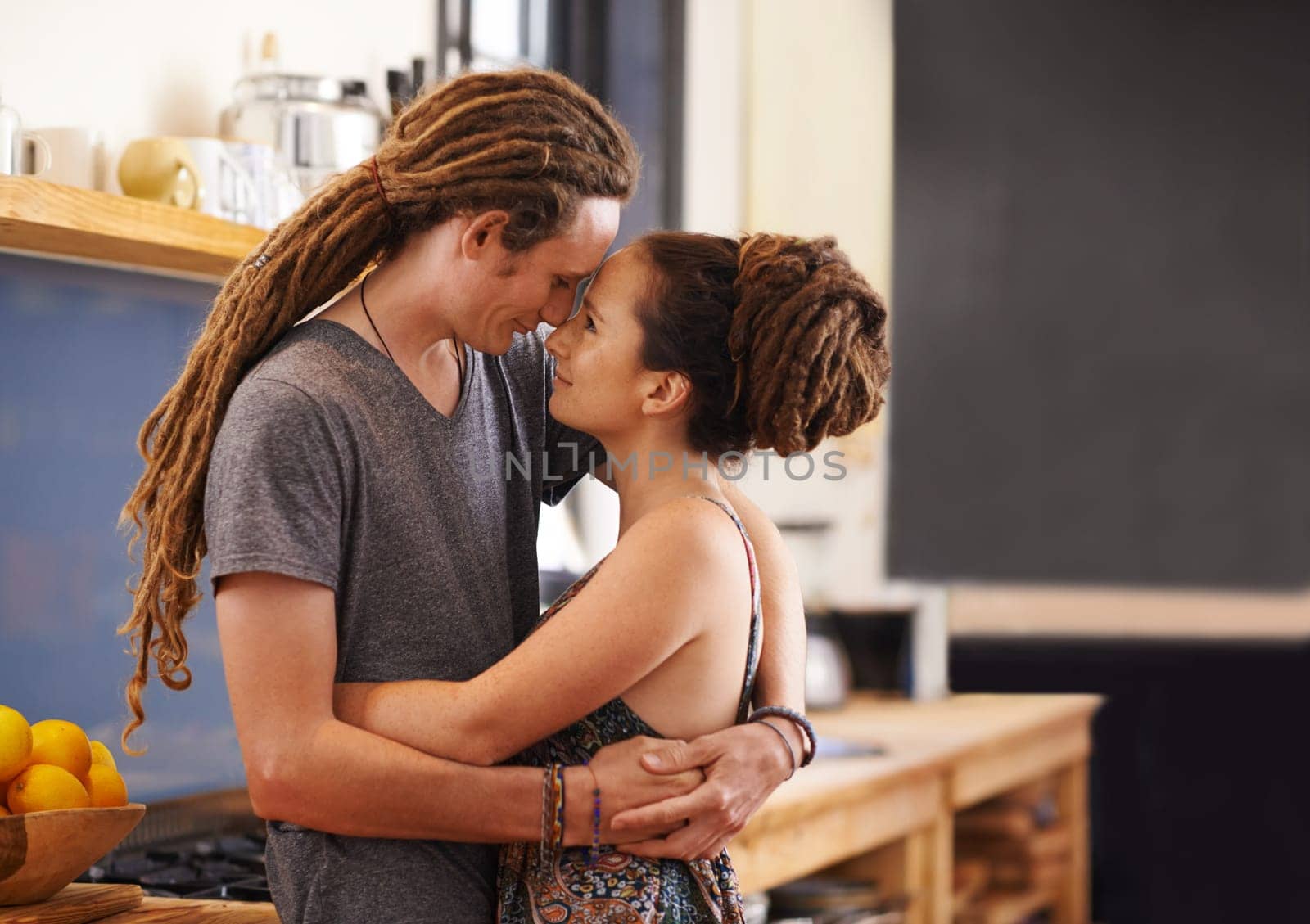 Hug, rasta and home with couple, happiness and bonding together with romance and relaxing. Marriage, apartment and embrace with love and dreadlocks with relationship and cheerful with man and woman by YuriArcurs