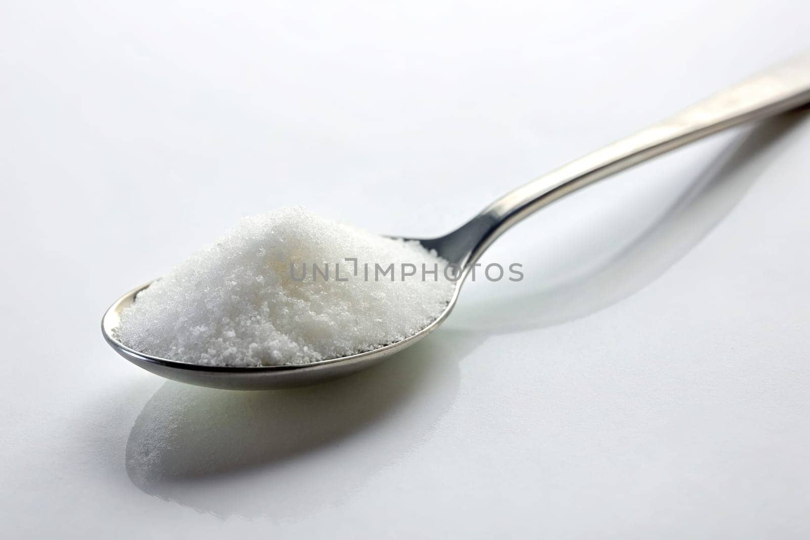 Sugar in a spoon on background, close-up. isolated. Food concept.
