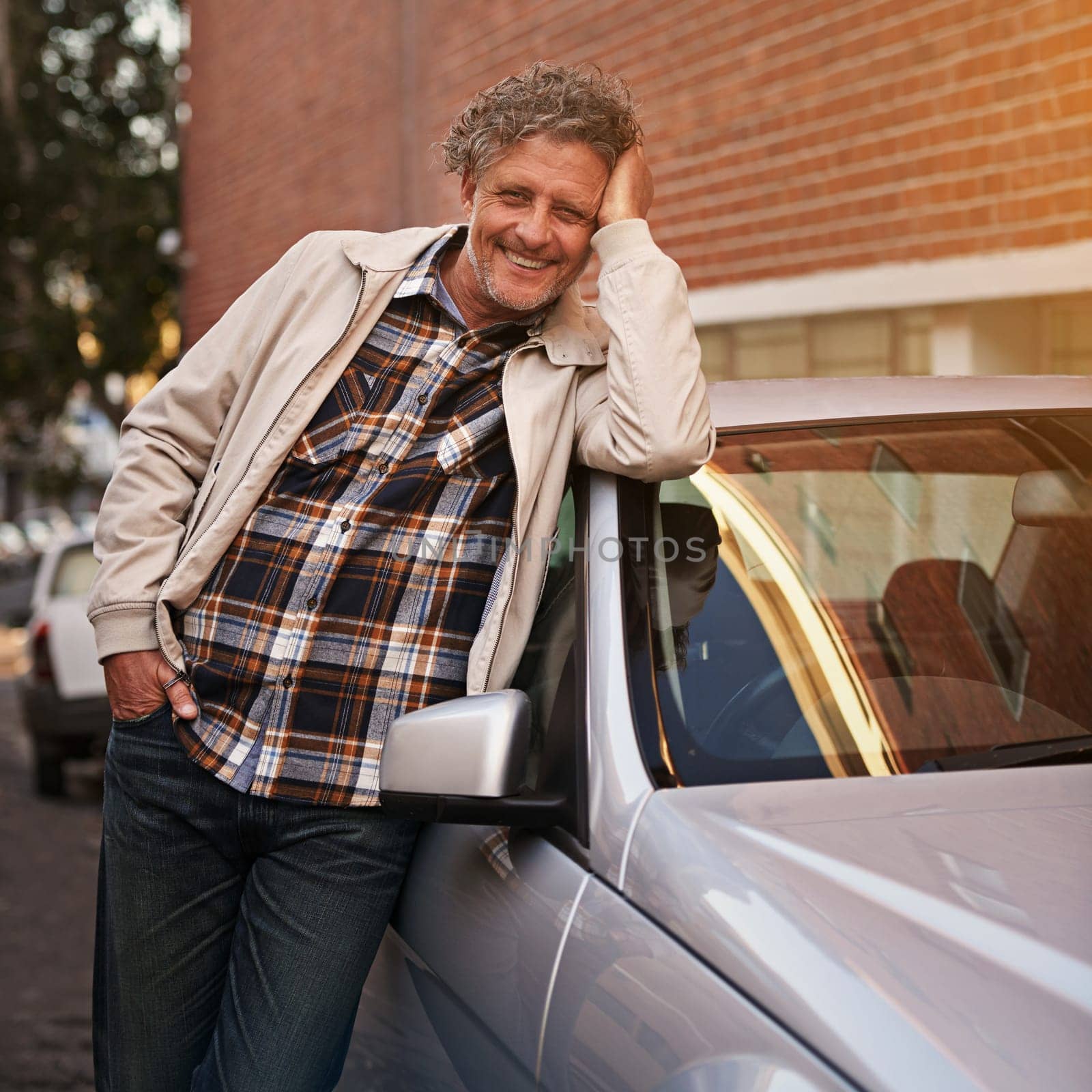 Man, portrait and smile at car in city for relax road trip or weekend commute, downtown or urban. Mature, male person and face at transportation for tourism adventure in New York, vehicle or vacation.